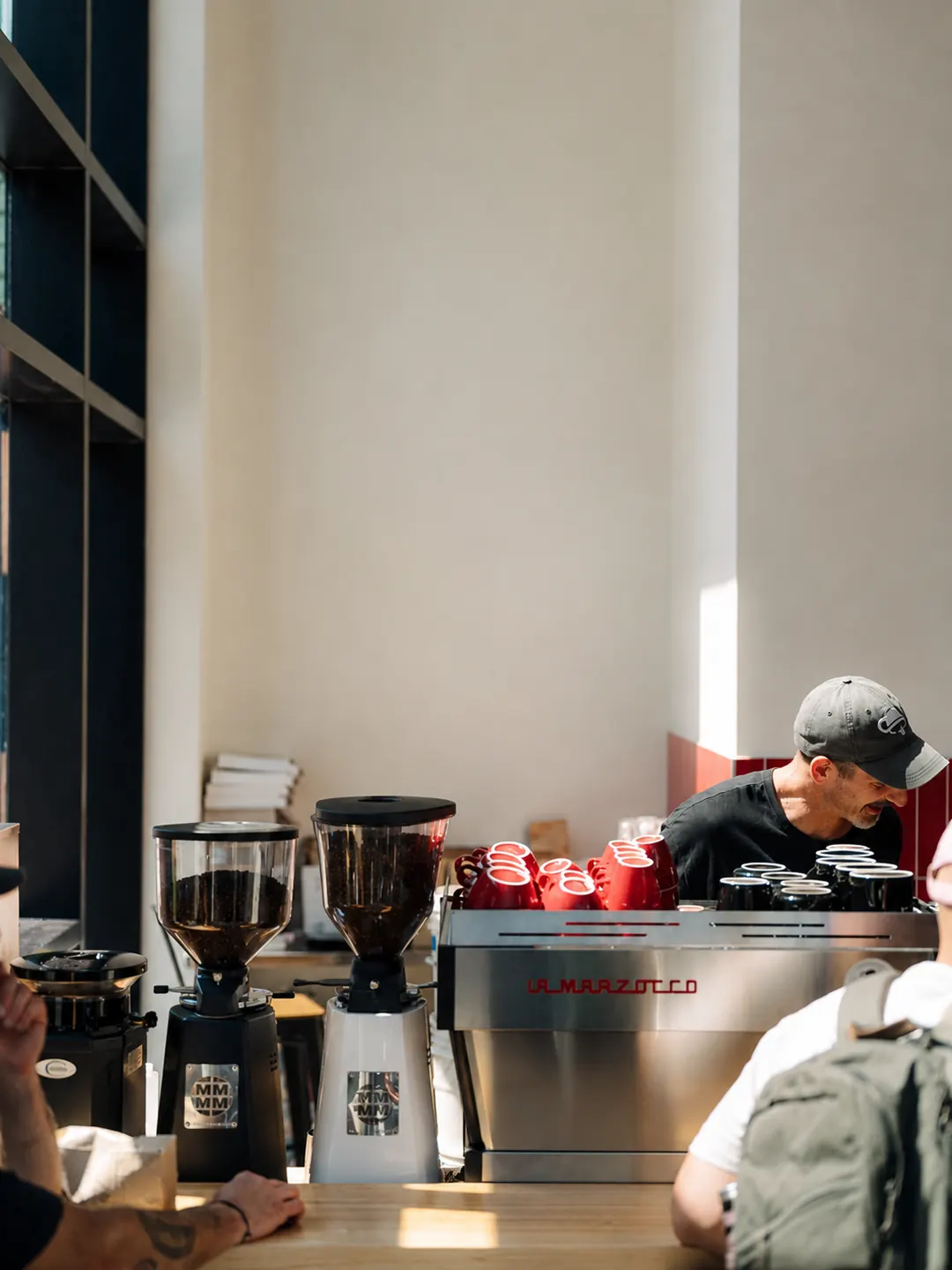 A barista preparing coffee behind the Espresso 46 espresso machine