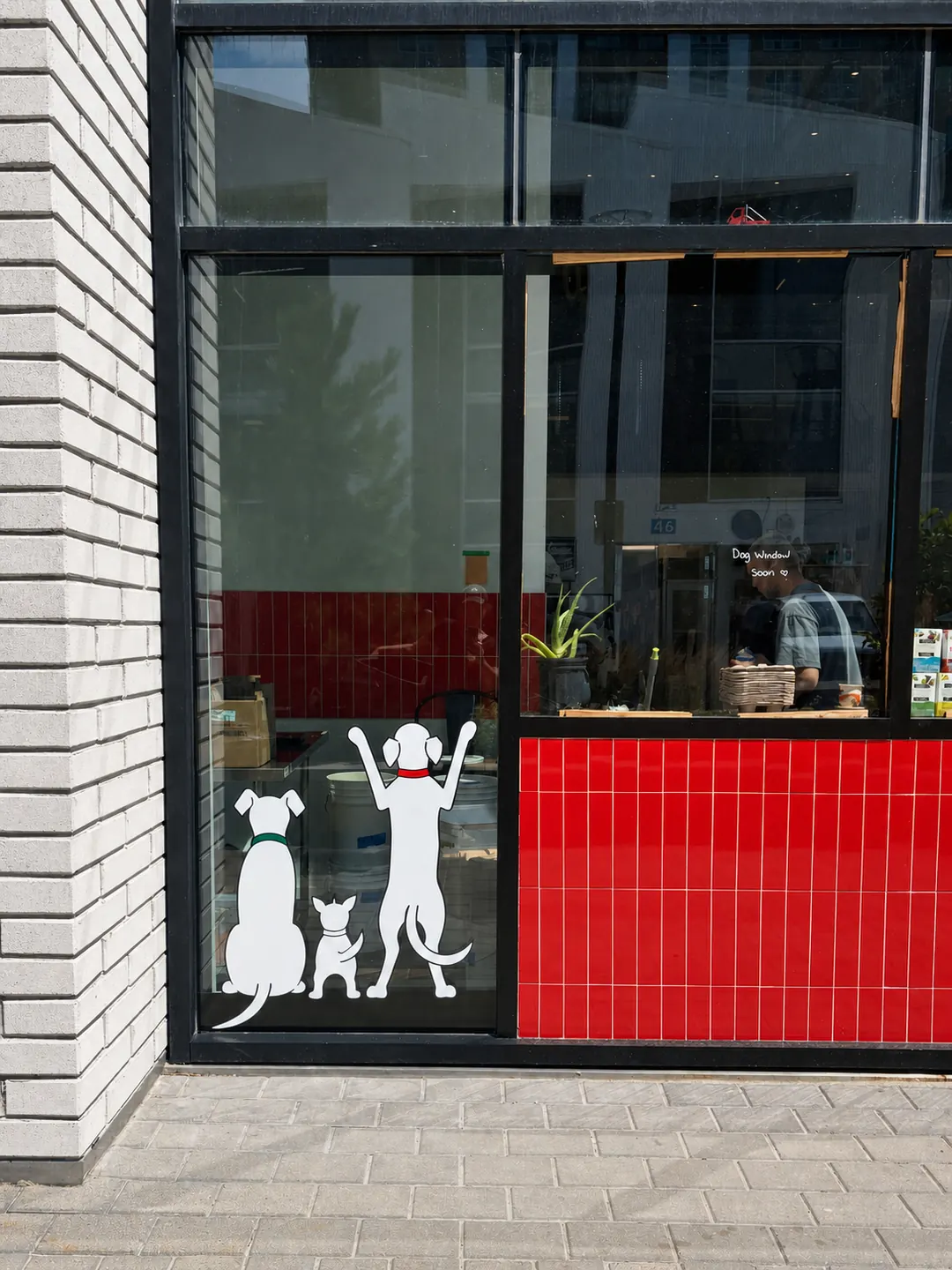 Red tiles and illustrated figures on the Espresso 46 storefront